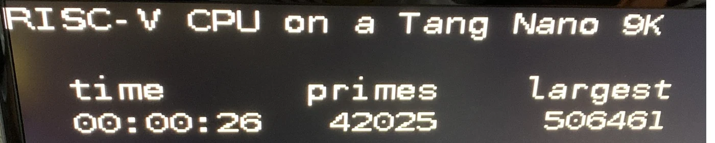 Tang Nano 9K FPGA running the RISC-V CPU, displaying elapsed time, 42,025 primes found and the largest prime, 506,461